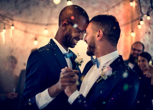 an interracial gay couple on their wedding day