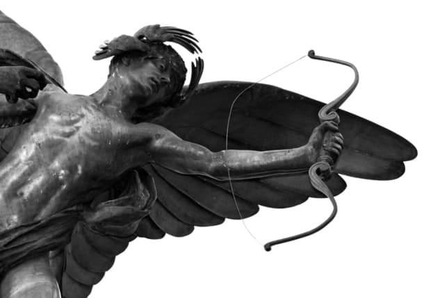 a sculpture of an angel with a bow and arrows