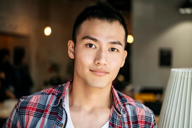 a portrait of a young asian oriental man indoors