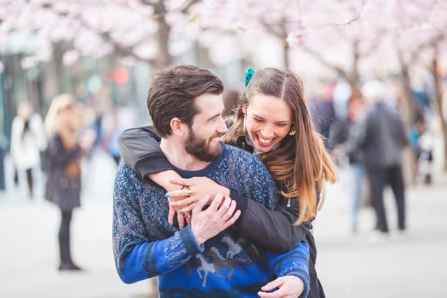 a young couple enjoying their date and having fun while going for a walk