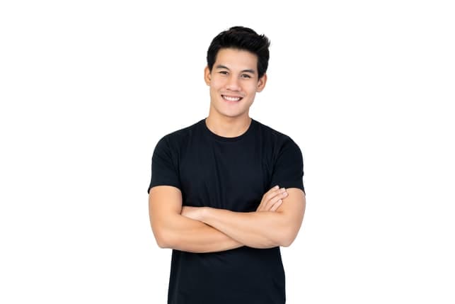 a young Asian guy in a black t-shirt is posing and smiling