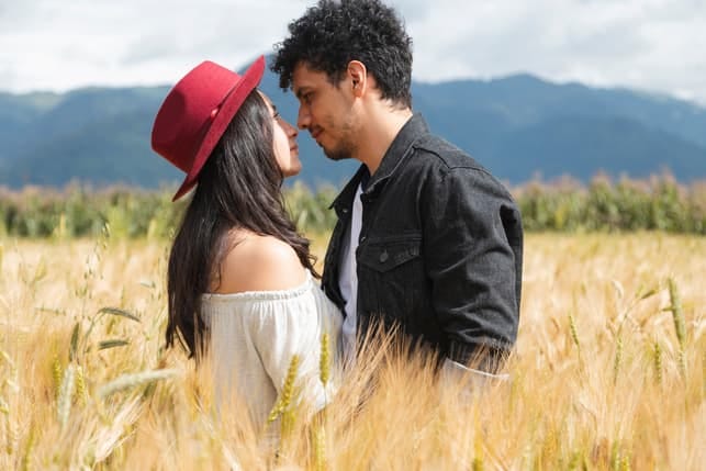 a beautiful mexican couple posing together in the field