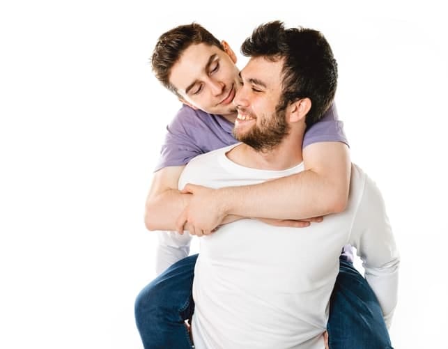 a young gay couple hugging