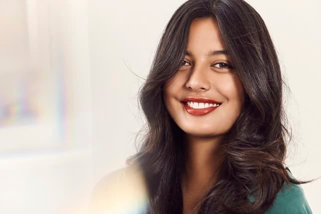 a portrait of a young woman in a pink dress