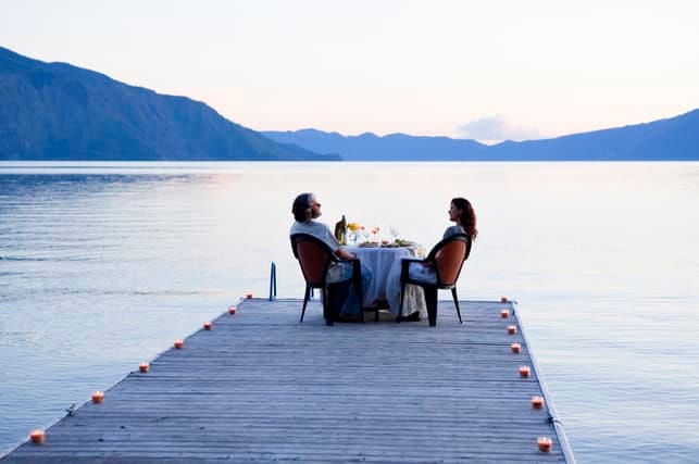 a couple enjoying their date at a pier