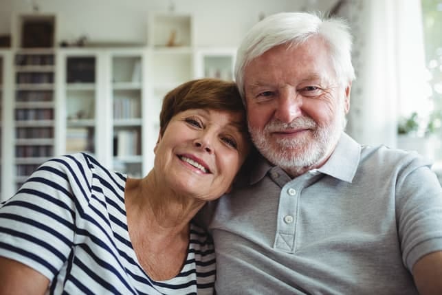 a happy senior couple posing and laughing together