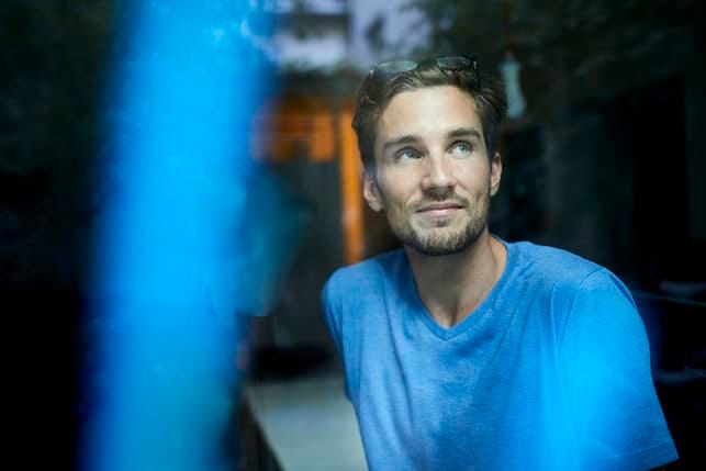 a portrait of a man wearing a blue shirt