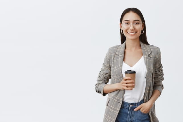 a young modern Mongolian girl smiling and posing with a cup of coffee