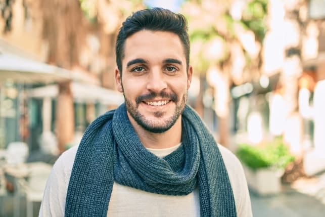 a portrait of a man wearing a scarf