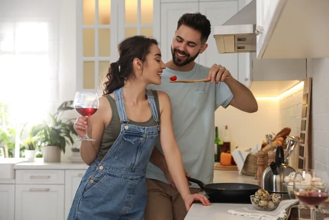 a beautiful young couple cooking together
