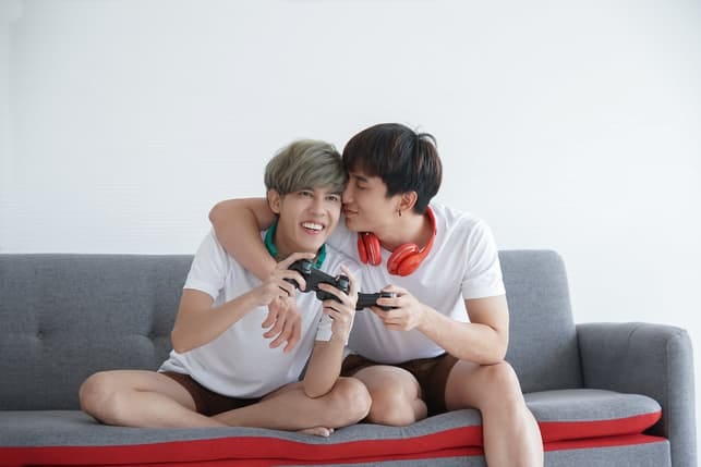 Asian boyfriends playing video games together
