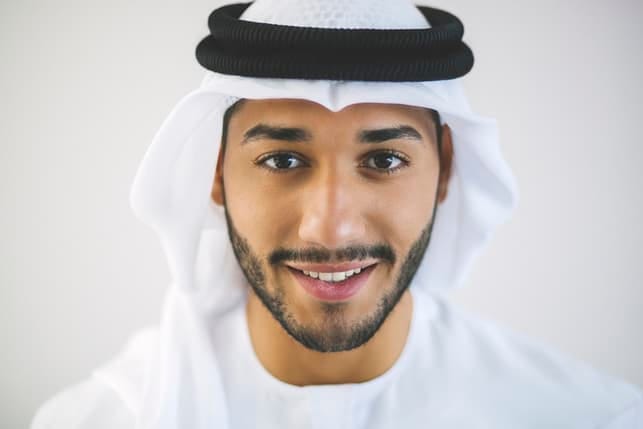 a portrait of a young Arab man in traditional clothes