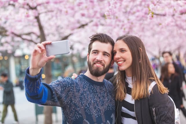 a couple taking a selfie together outdoors