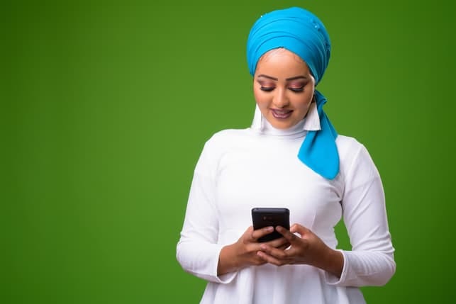 a modern Muslim woman using her smartphone