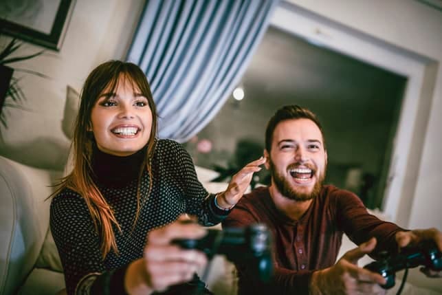 an excited couple playing video games together