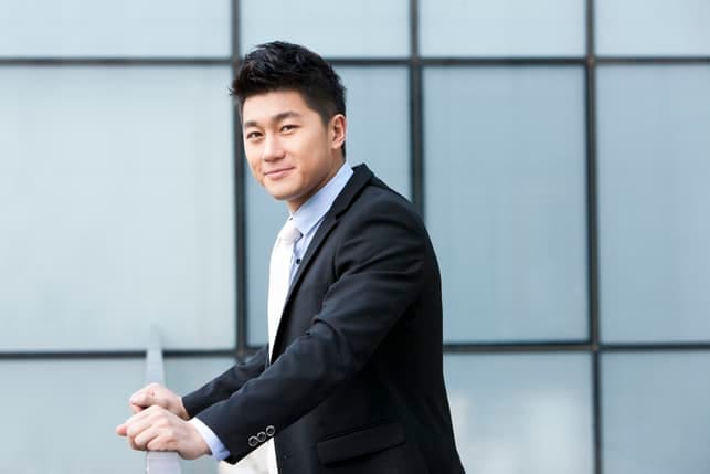 an asian man posing on a yellow background