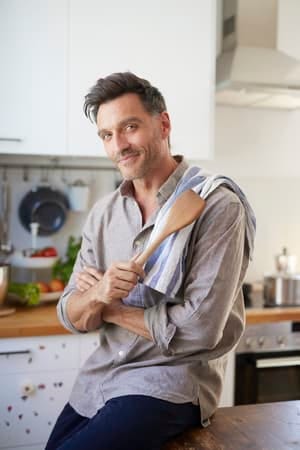 an attractive middle-aged man cooking