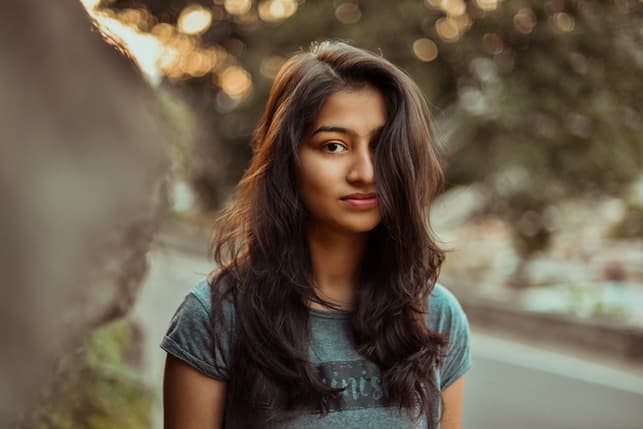 a portrait of a young oriental woman taken outdoors