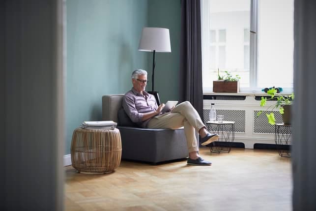 lovely man sitting at home by the window