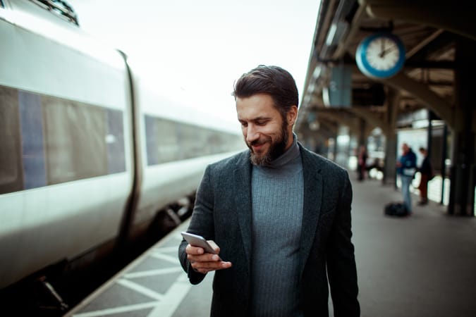 A man is reading a text on his smartphone