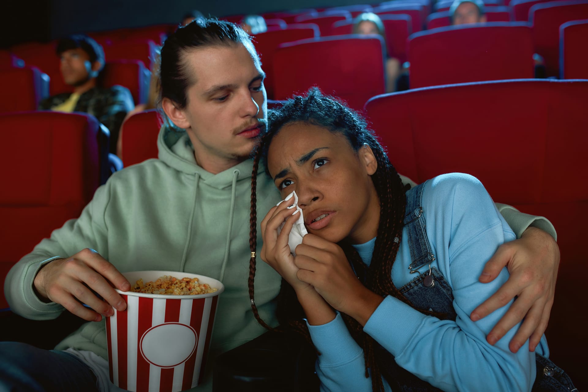 A couple on a date in a movie theater